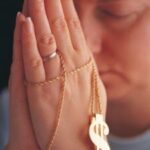 542421-fbwoman-praying-with-money-rosary-posters-1094537